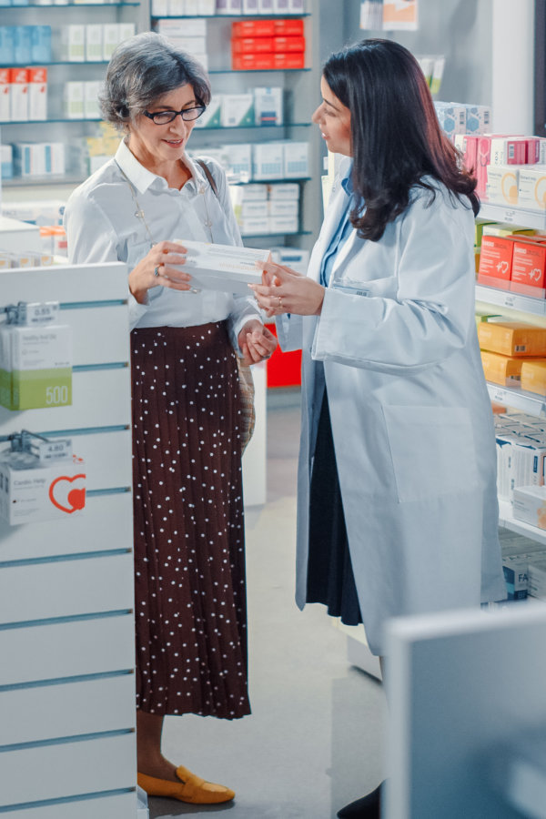 senior woman talking to pharmacist